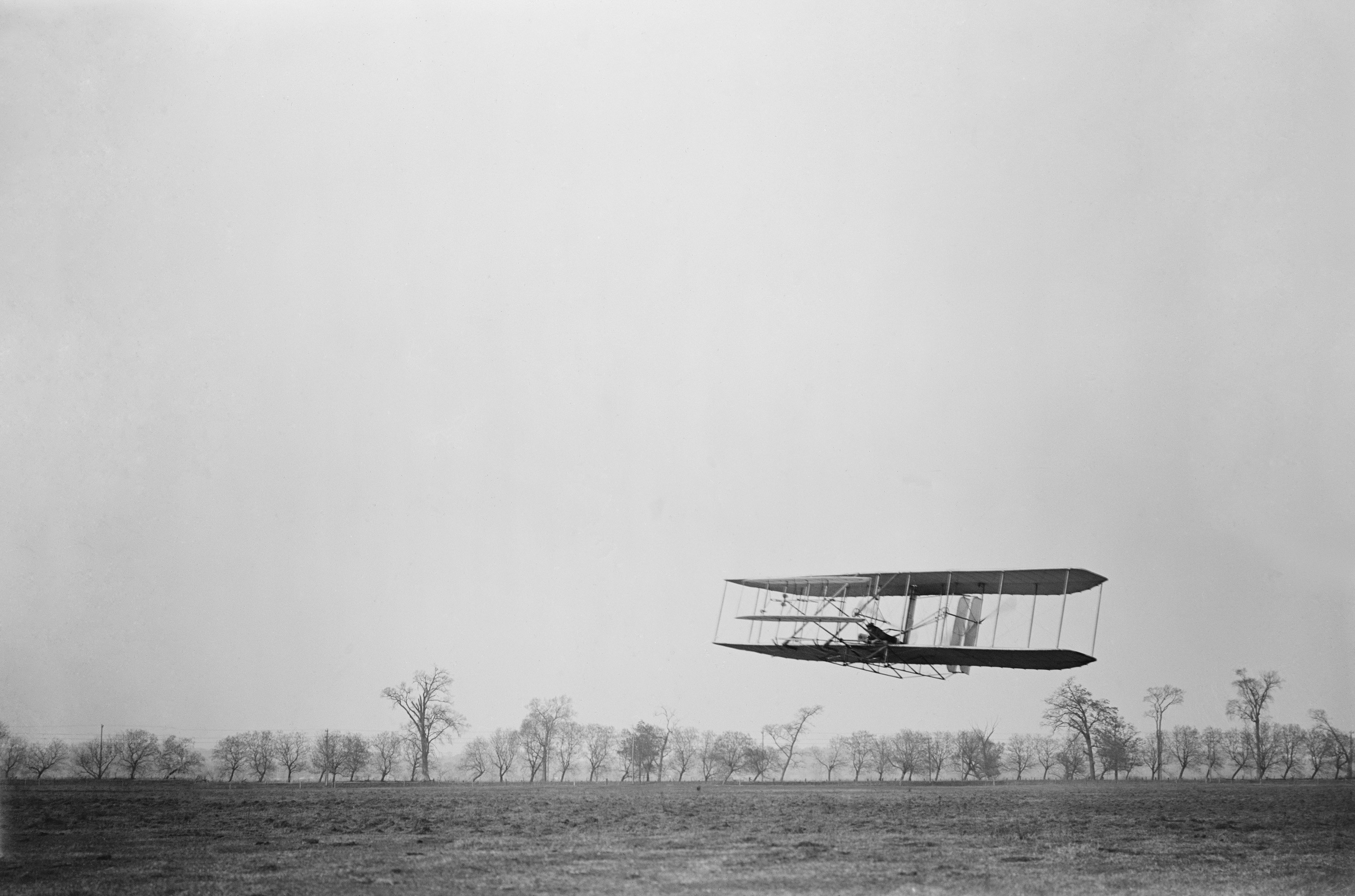 Historic image of the Wright brothers testing their early aircraft on open field